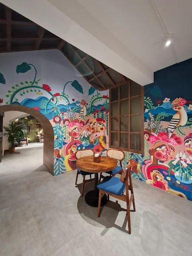 Hand-painted café wall mural by Oikar Studio created by a mural artist in Salt Lake, featuring folk-inspired artwork inside Country House Café