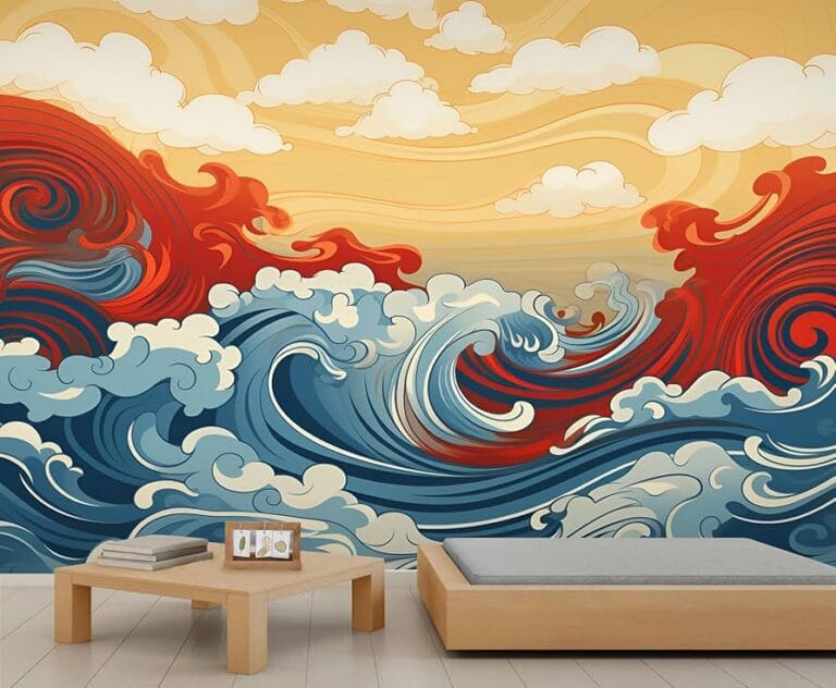 A minimalist bedroom featuring a large, stylized wall mural of crashing ocean waves in blue, red, and white. The artwork is influenced by Japanese Ukiyo-e style, set against a golden sky with soft white clouds. A low wooden platform bed and a simple coffee table sit in the foreground.