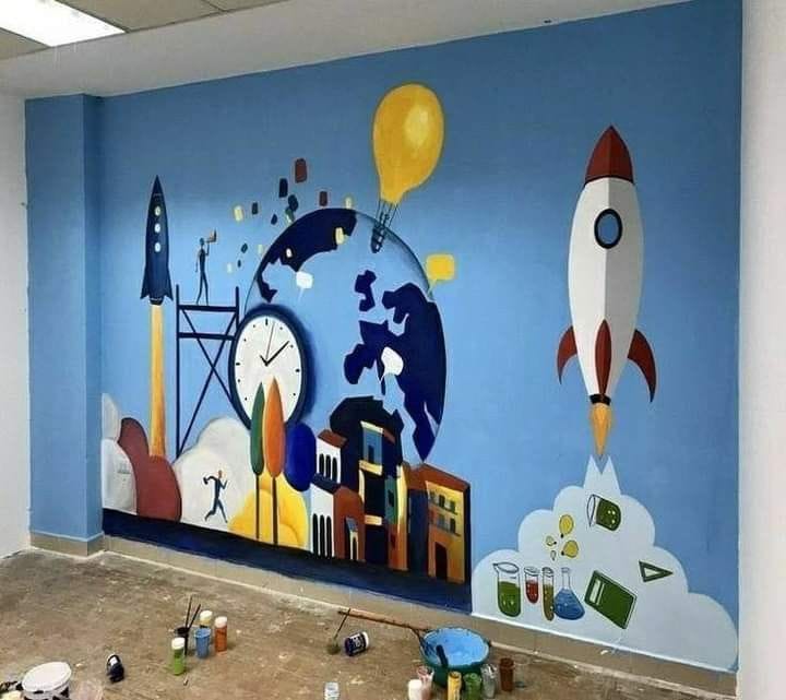 A bright blue wall mural depicting a rocket ship taking off, a globe, a large clock, and various scientific laboratory icons.