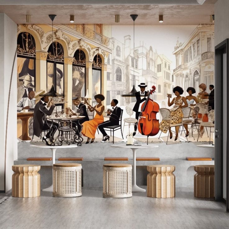 A photo looking down the length of a modern cafe, showing four rattan-sided drum stools in the foreground, three small round tables, and a large, intricate mural of a bustling vintage European street scene with Black people dining, chatting, and one man playing a double bass.