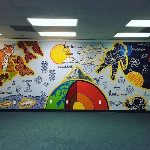 A colorful educational mural featuring a tiger, butterflies, an astronaut in space, and a cross-section of the Earth.