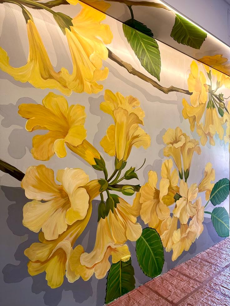 Hand-painted yellow floral wall mural with detailed botanical artwork for luxury interior spaces in Kolkata.
