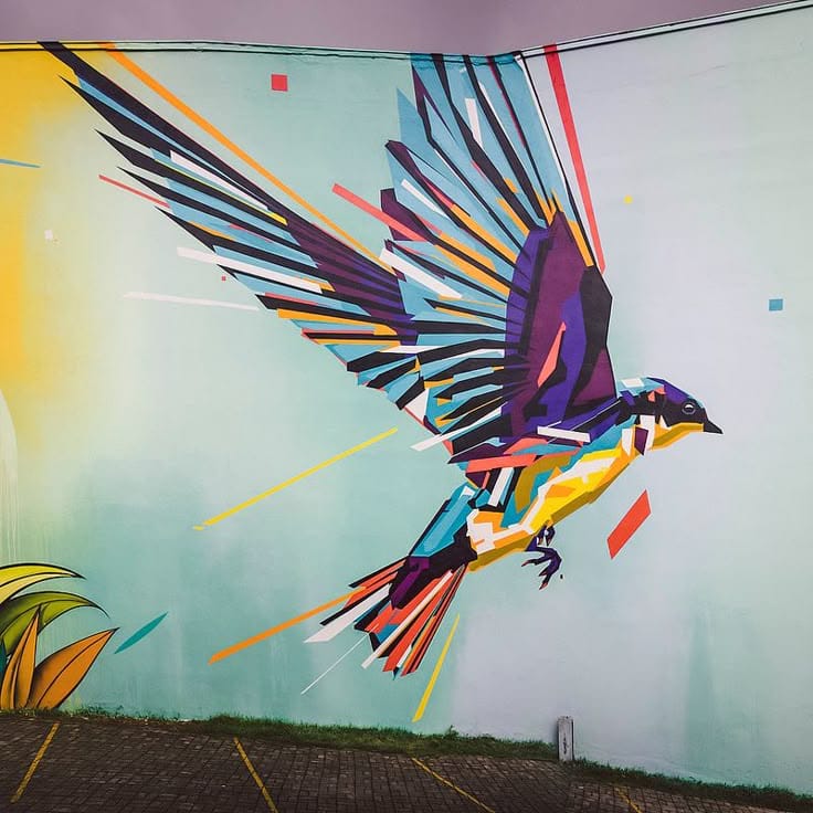 Colorful geometric bird mural art painted on an outdoor wall with abstract modern design by mural artists in Kolkata.